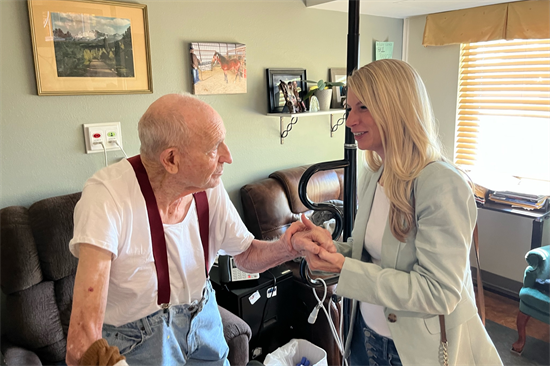 Rep. Pettersen speaks to a resident at Bruce McCandless Veterans Community Living Center