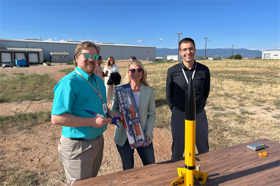 Rep. Pettersen poses with a model rocket at Estes Rockets 